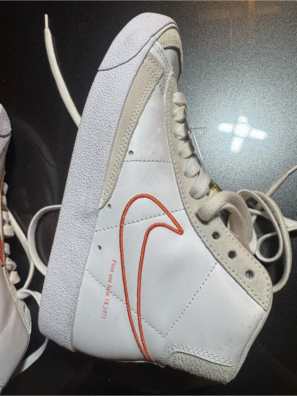 Nike White High-Top Sneakers with Orange Swoosh